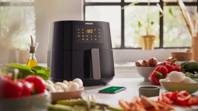 A Philips Essential XL Airfryer surrounded by food
