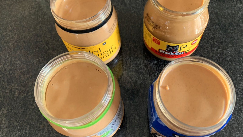 Four open peanut butter jars