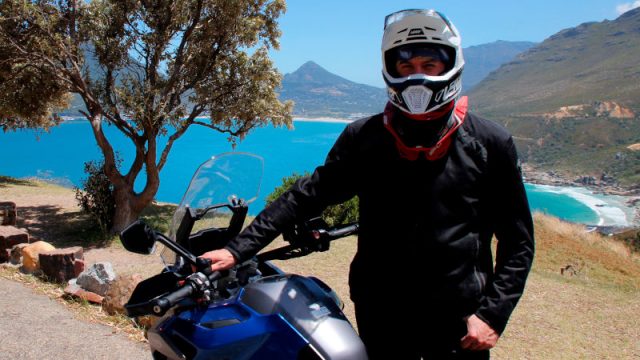 A rider wearing a Leatt 7.5 motorcycle helmet.
