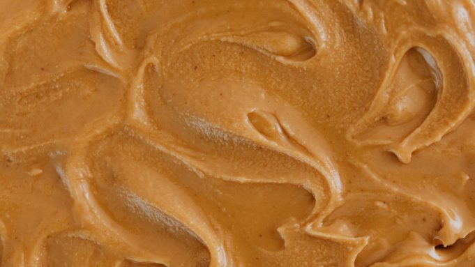 Woollies vs Yum Yum: who makes the best caramel peanut butter? A beautiful close-up of peanut butter