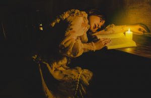 Energizer Vision 1200 Rechargeable Lantern – Review A beautiful woman reading a book by candlelight.