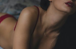 Liquid Gold Lube – Review A woman wearing red lipstick and a red knickers.