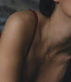 Liquid Gold Lube – Review A woman wearing red lipstick and a red knickers.