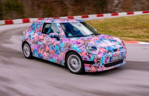 Next MINI Cooper could have a 400 km range The 2024 electric Mini Cooper, in pink camo, going round the track.